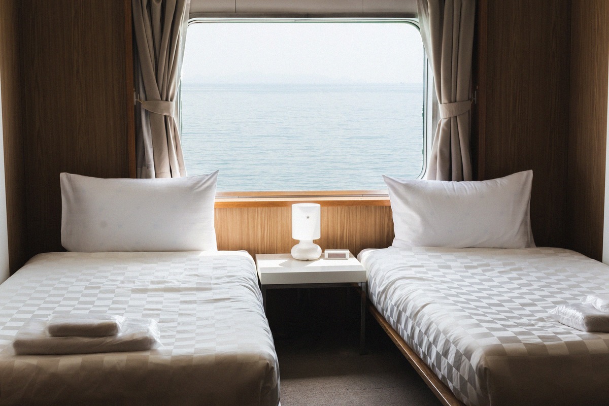 Twin cabin on a ferry with a large window and sea view